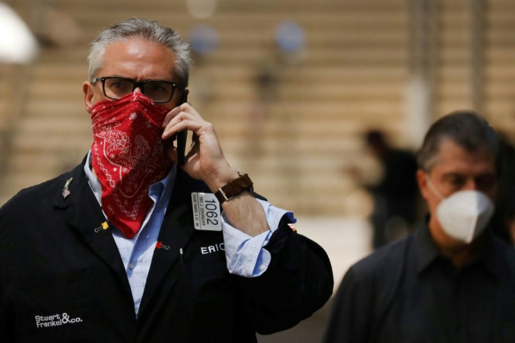 A trader last year shown in front of the New York Stock Exchange, which plans to ease more of its Covid-19 restrictions