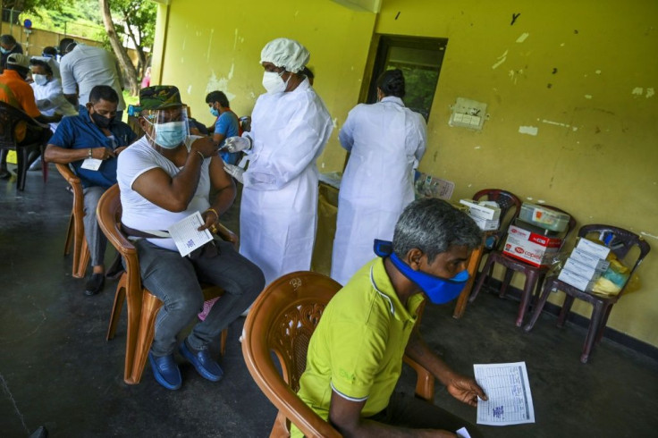 A health worker inoculates a man with a second dose of the Covishield coronavirus vaccine in Colombo, Sri Lanka