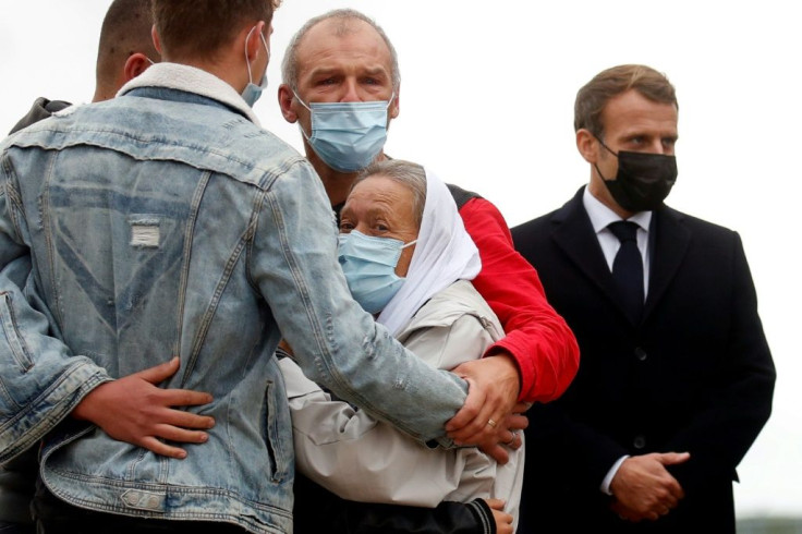 Hostage release: French President Emmanuel Macron, right, stands next to French aid worker Sophie Petronin, centre, as she is welcomed by her family on her return to France