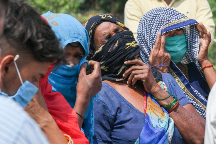 Relatives grieve as they arrive for the cremation of a loved one who died due to Covid-19, at a crematorium in Moradabad, India on May 5, 2021