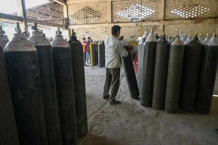 An employee refills cylinders with oxygen for Covid-19patients, at a refilling centre in Moradabad