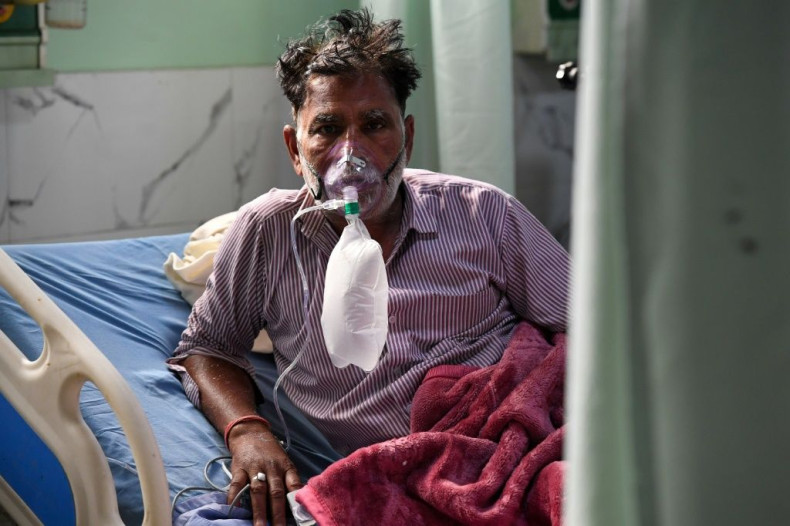 A Covid-19 coronavirus patient breaths with the help of an oxygen mask inside the Intensive Care Unit (ICU) of the Teerthanker Mahaveer University (TMU) hospital in Moradabad