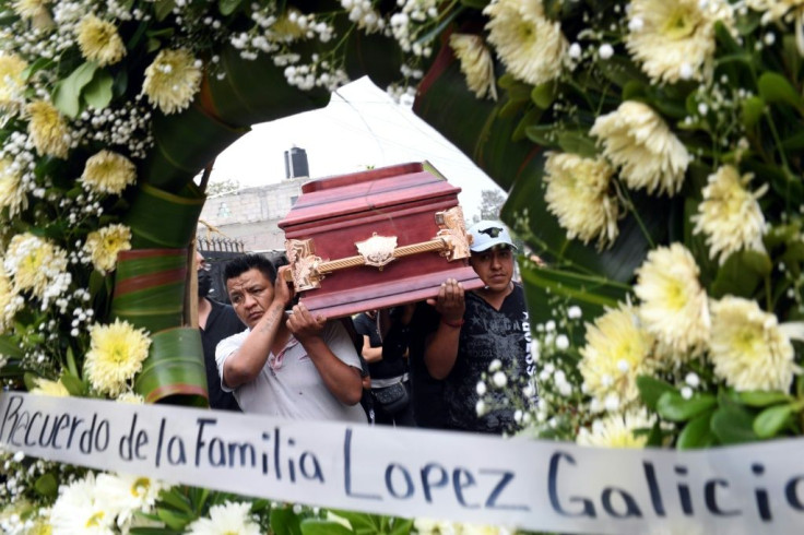 Relatives carry a coffin with the remains of Juan Luis Diaz Galicia, who was among the victims