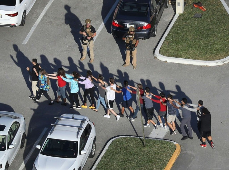 Students and staff are brought out of the Marjory Stoneman Douglas High School in Florida after the February 14, 2018 deadly shooting