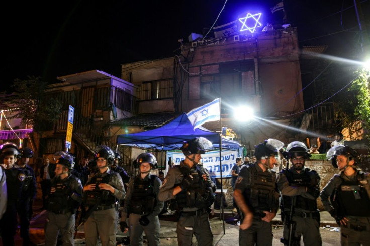 Israeli border police stand guard in front of a Sheikh Jarrah home occupied by Jewish settlers, outside which a far-right lawmaker has set up a makeshift parliamentary office