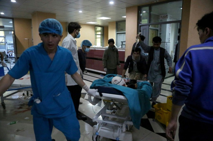 An injured man is being brought on a stretcher to a hospital following a blast outside a school in the west Kabul district of Dasht-e-Barchi