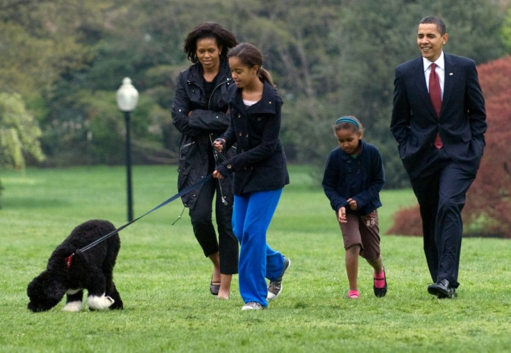 Malia Obama walks her new six-month old Portuguese water dog Bo alongside US President Barack Obama, Sasha Obama and First Lady Michelle Obama on the South Lawn of the White House in Washington, DC, on April 14, 2009