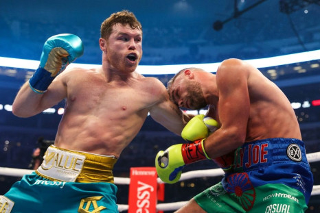 Mexican champion Saul "Canelo" Alvarez (left) throughs a punch at British boxer Billy Joe Saunders during their super middleweight title fight at the AT&T Stadium in Arlington, Texas