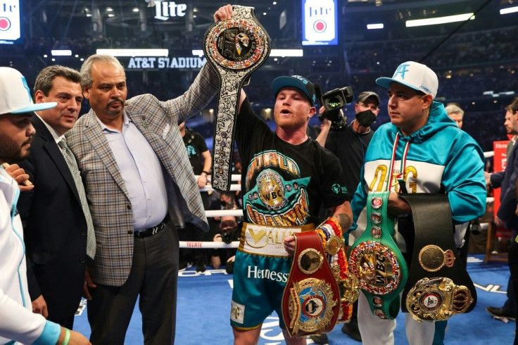 One title to go: Saul "Canelo" Alvarez shows off his championship belts after defeating Billy Joe Saunders during their super middleweight unification fight
