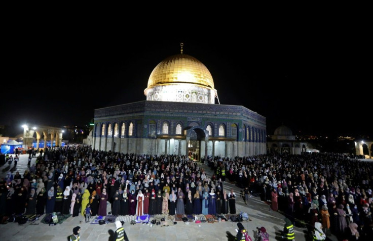 Palestinian faithful hold night-time prayers in front of the Dome of the Rock in the Old City of Israeli-annexed east Jerusalem