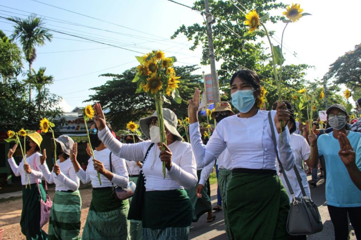 (FILES) In this file handout photo taken and released by Dawei Watch on April 21, 2021, protesters hold sunflowers during a demonstration against the military coup in Dawei.