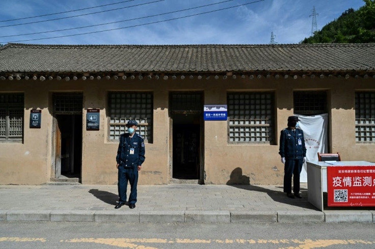 Guards stand outside a building during a government-organised media tour in Yan'an, a western Chinese city that bills itself as a 'Red Holy Land'
