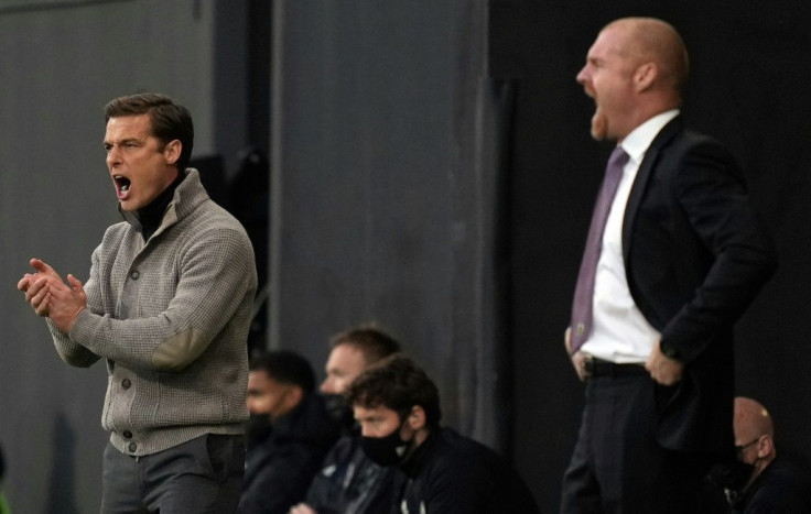 Going down, staying up - Rival managers Scott Parker (Fulham, L) and and Sean Dyche (Burnley R) urge their sides on during a x-x win for Burnley that saw Fulham relegated from the Premier League