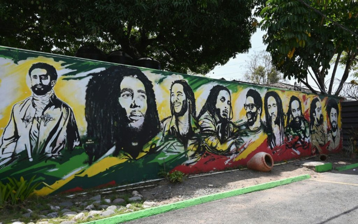 A mural depicting Ethiopian Emperor Haile Selassie I, Jamaican Reggae legend Bob Marley and his seven sons is seen on the grounds of the Bob Marley Museum in Kingston, Jamaica, on May 17, 2019