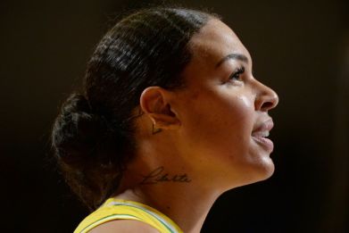 Australia's Liz Cambage has withdrawn her threat to boycott the Tokyo Olympics over "whitewashed" team photo-shoots, but vowed to remain outspoken on social justice issues