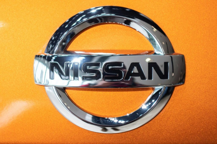 Nissan has said it has trimmed its annual net loss but the outlook remains clouded by a global chip shortage