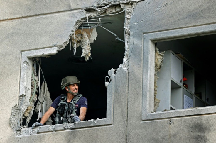 An Israeli sapper checks a damaged apartment in the southern Israeli city of Ashkelon after rockets were fired by the Hamas movement from the Gaza Strip towards Israel overnight