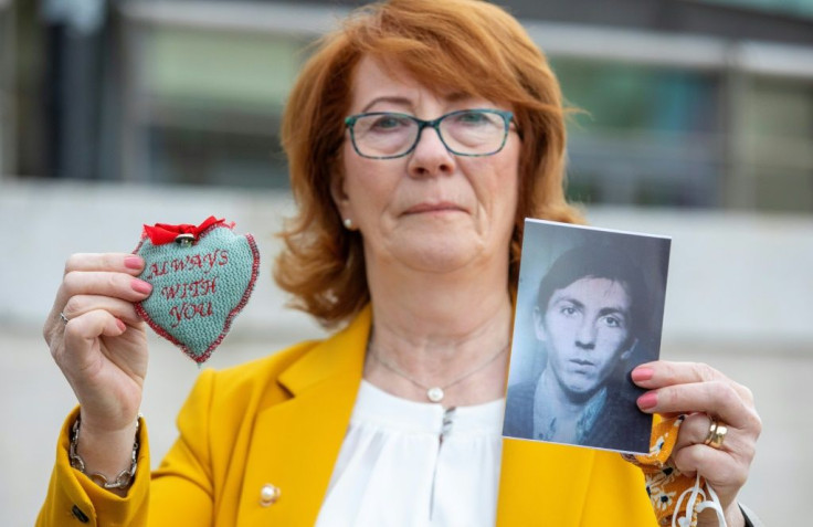 Rita Bonner holds up a picture of her brother John Laverty, who was one of those killed