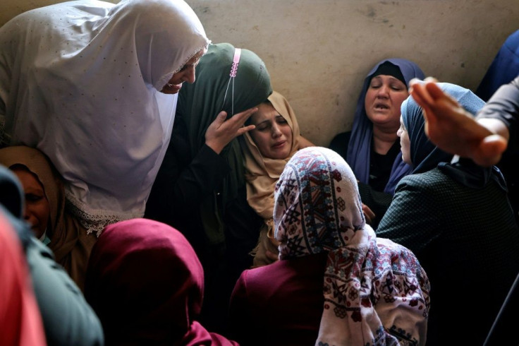 The mother of Palestinian Hussein Hamad, 11, is comforted by mourners after he was killed in an Israeli air strike in the northern Gaza Strip