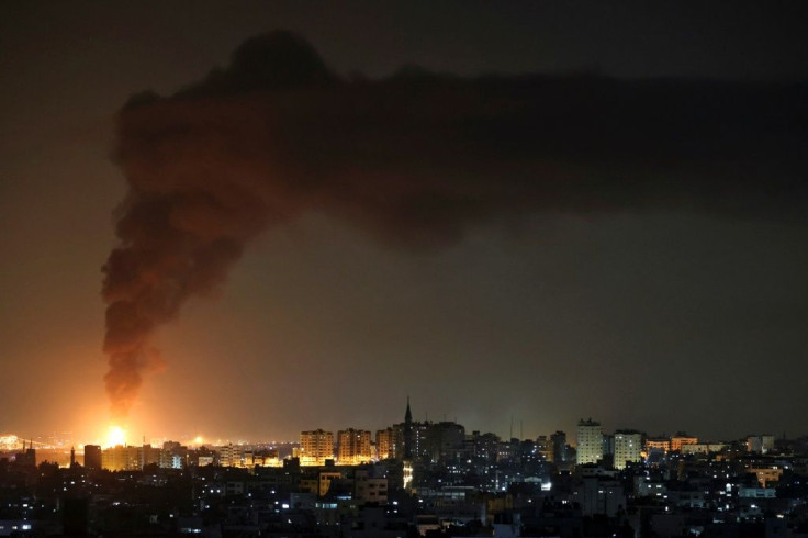 A huge column of smoke seen from Gaza city billows from an oil facility in the southern Israeli city of Ashkelon, on May 11, 2021, after rockets were fired by the Palestinian Hamas movement from the Gaza Strip towards Israel.