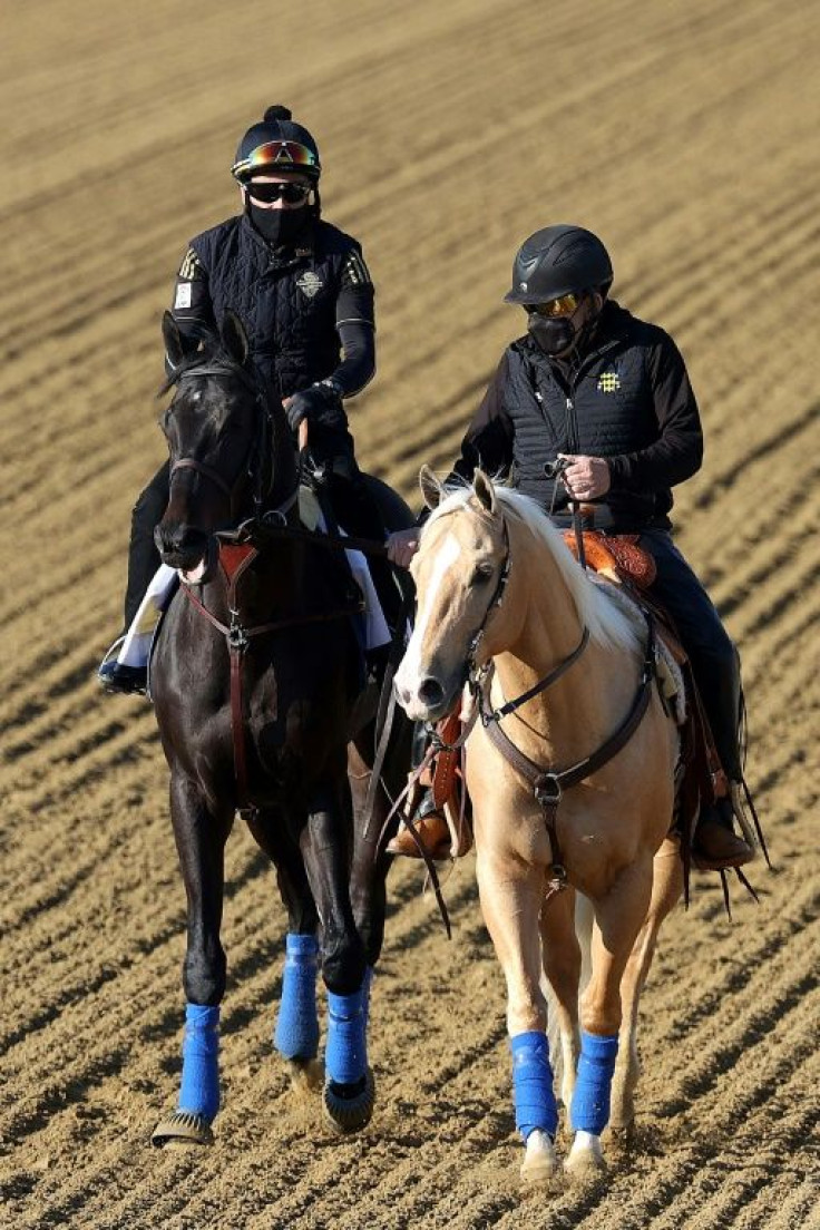 Kentucky Derby winner Medina Spirit, left, works Tuesday at Pimlico, where the Bob Baffert-trained colt will compete in Saturday's Preakness