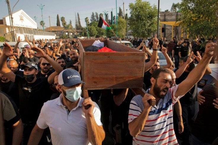 Arab Israelis hold a funeral for Mousa Hassouna who was killed during clashes with Israeli security forces during a demonstration