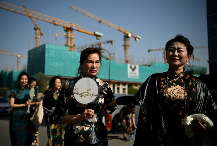 The "Fashion Grandmas" dressed in traditional costumes during a rehearsal for a performance on a television show in Beijing