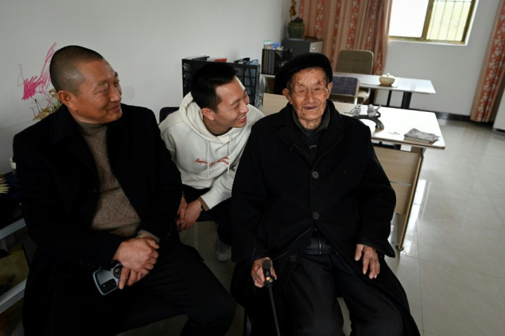 Qian Zuhua (R), 101, still works at his son's screw production factory, matching metal nuts and bolts with his nimble fingers