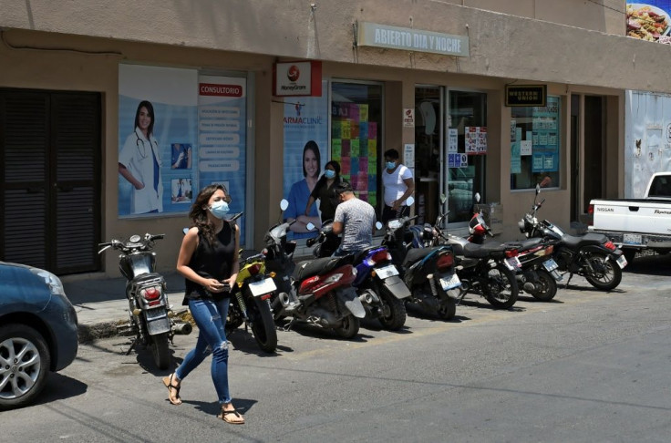 Maria Fernanda Camano leaves the money transfer office in Izucar de Matamoros in central Mexico where she receives remittances from her father in the United States