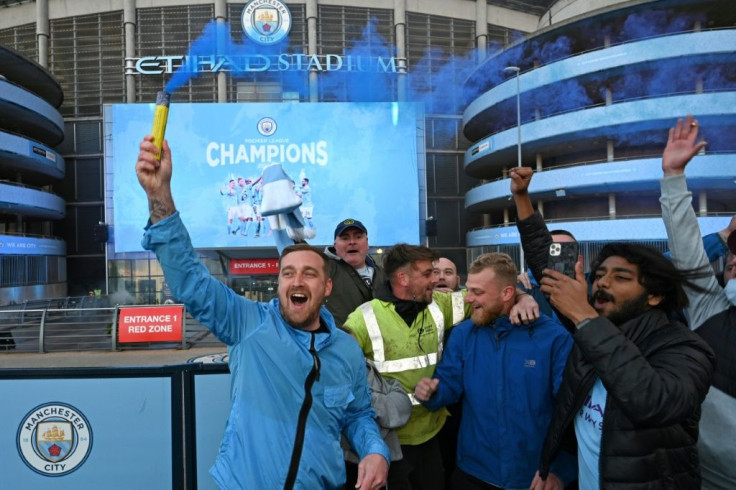 Blue moon rising: Manchester City fans celebrate clincning the Premier League title for the fifth time in nine years