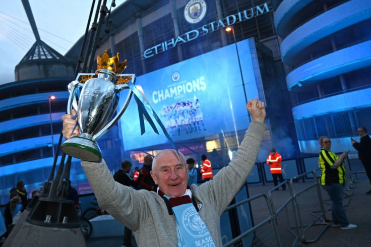 Trophy time: Man City fans celebrate winning the Premier League outside the Etihad Stadium