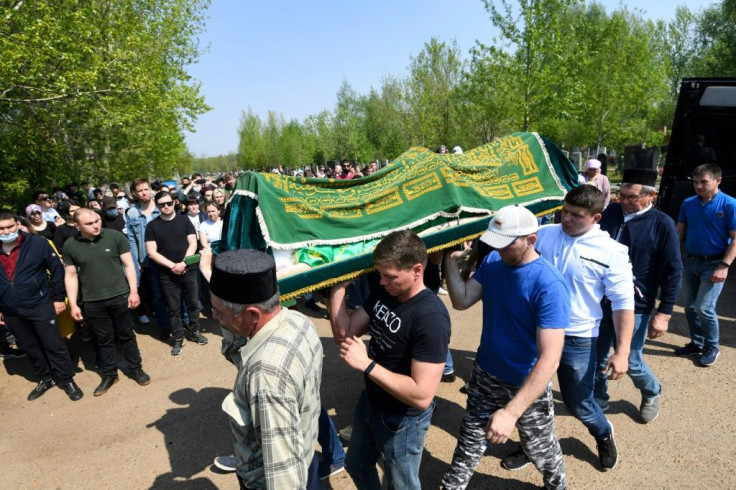 Mourners carry the casket of teacher Elvira Ignatyeva, who was killed in the shooting