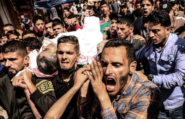 Mourners carry the body of Majd Abu Saadahthe, a Palestinian killed in an Israeli airstike, during his funeral in the town of Khan Yunis in the southern Gaza Strip