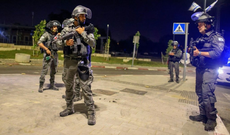Israeli security forces are seen in a street in Lod near Tel Aviv on May 12