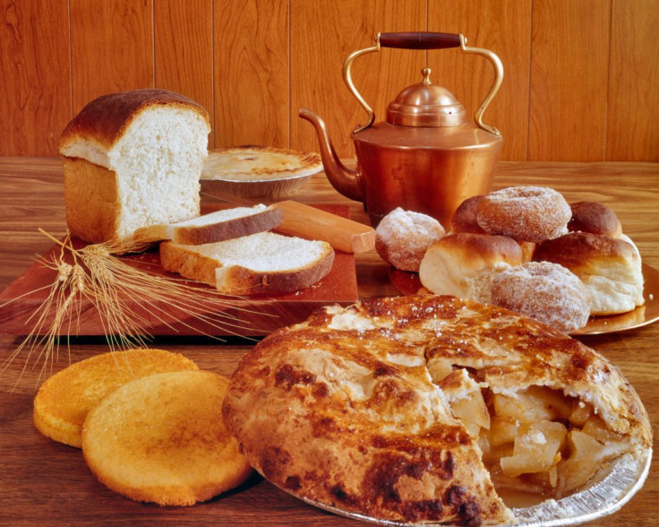 1970s Variety Of Baked Goods With Cooper Kettle Sliced White Bread Donuts Rolls Apple Pie Corn Muffins.