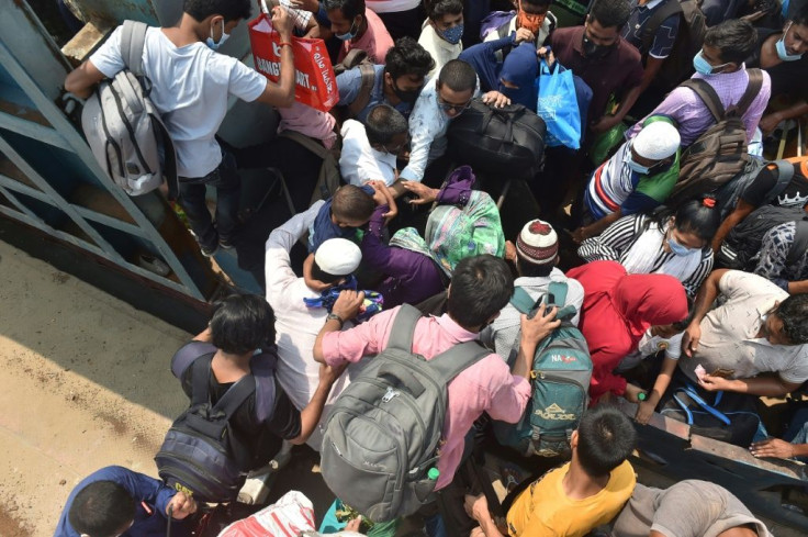 Bangladeshis board a crowded ferry to head home for the Eid al-Fitr holiday in defiance of a coronavirus lockdown
