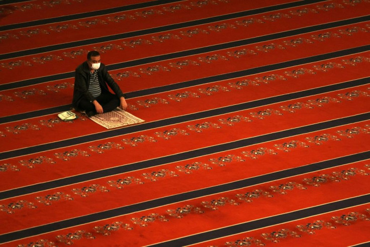 A man wearing a protective face mask and maintaining social distancing perform the Eid al-Fitr prayer amid the coronavirus, Covid-19 pandemic, at Kocatepe Mosque in Ankara, Turkey