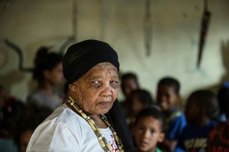 Katrina Esau, one of the last remaining speakers of a Khoi San language, Tuu, teaches her native tongue to children in this 2015 picture. Once widely spoken, Tuu was forcibly replaced by Afrikaans under apartheid, and in 1978 was declared extinct