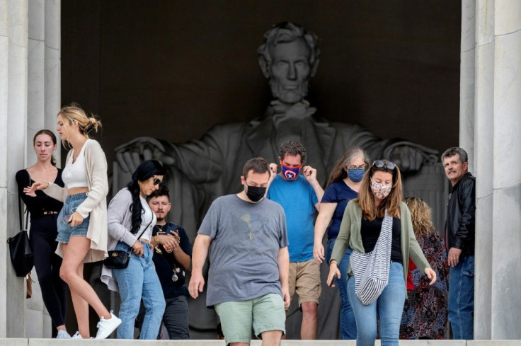 Some could still be seen wearing masks around Washington landmarks like the Lincoln Memorial Friday