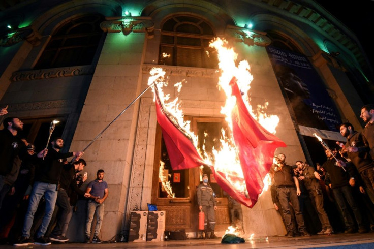 Armenians set fire to the Turkish and Azerbaijani flags in Yerevan on April 23, 2021 during commemorations of what the United States has recognized as a genocide against Armenians by the Ottoman Empire