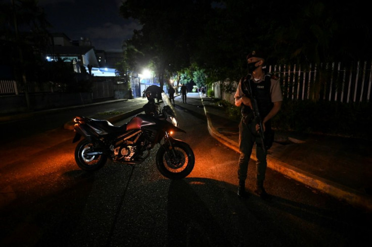 A member of the Bolivarian National Guard keeps watch outside the Venezuelan newspaper El Nacional in Caracas on May 14, 2021