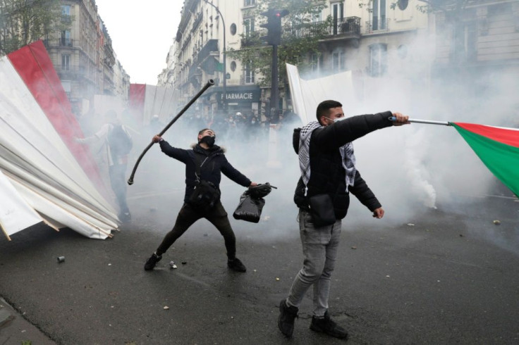 A protester throws a metal bar during a demonstration in Paris