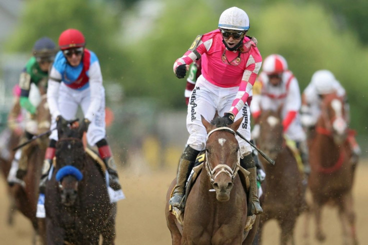 Jockey Flavien Prat celebrates after piloting Rombauer to victory in the Preakness Stakes