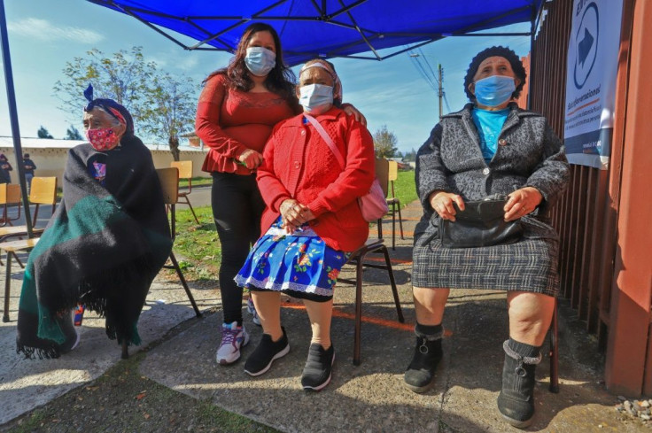 Mapuche indigenous women wait to vote during Chile's elections in Temuco on March 15, 2021