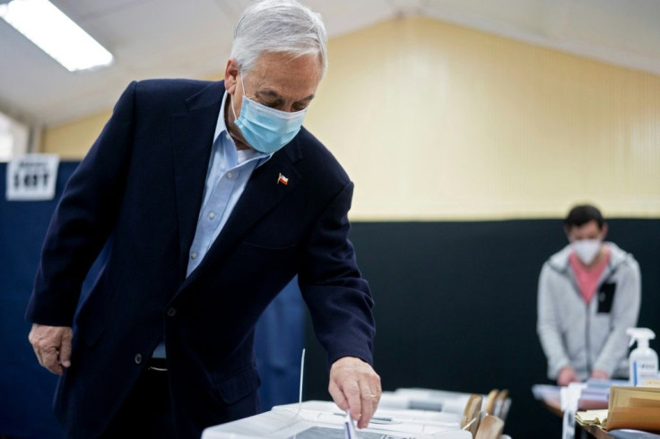 Chilean President Sebastian Pinera casts his vote in Santiago during elections to choose mayors, councillors and a commission to rewrite the constitution on March 15, 2021