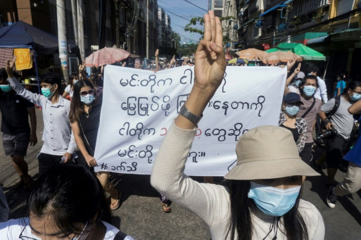 Anti-coup protesters flash a three-fingered salute in Myanmar