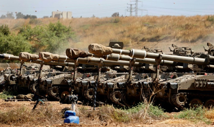 Israeli tanks are pictured at their position along the border with the Palestinian Gaza Strip on May 15