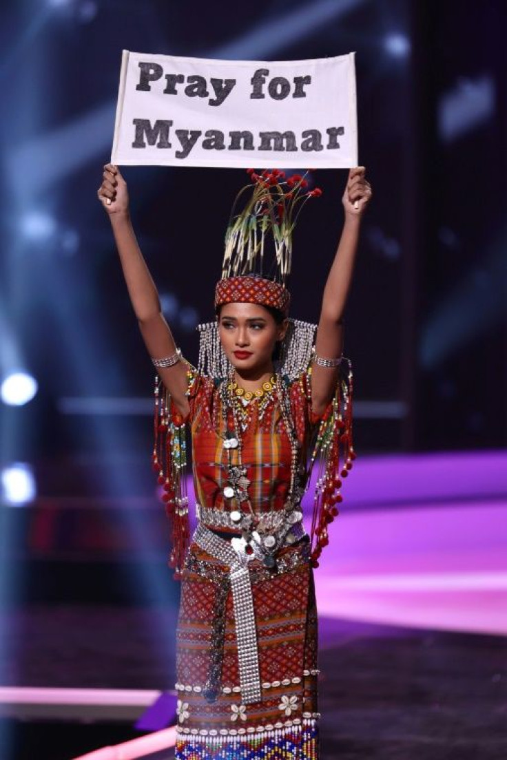 Miss Myanmar Thuzar Wint Lwin (pictured May 13, 2021) wore an outfit beaded in traditional Burmese patterns and held up a sign that said, "Pray for Myanmar" during the national costume portion of the Miss Universe pageant