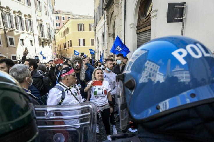 Social media has given the conspiracy movement a global aesthetic, as with the Italian demonstrator (Rear C) seen costumed as one of the January 6 rioters at the US Capitol