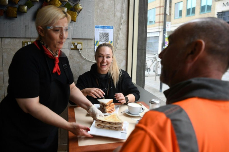 Customers tuck in to sandwiches at Barbarellas, a traditional family-run "greasy spoon" cafe near Waterloo station
